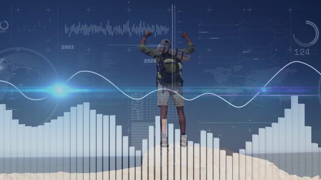 Adult male hiker performing short celebratory jump raising arms on mound, HUD data elements syncing