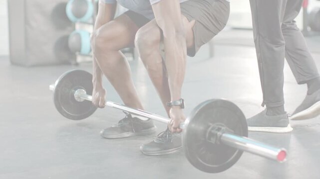 Lifter gripping barbell starting deadlift, coach watching, lines showing hip drive for fitness