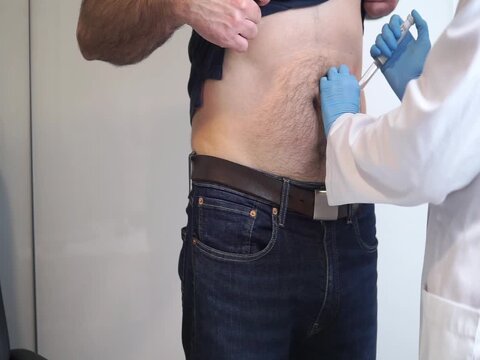 Demonstrating the administration of subcutaneous medication, a common method for GLP-1 receptor agonists like semaglutide.