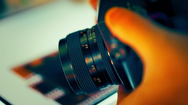Vintage camera lens focus adjustment hand film photography background macro. Closeup detail aperture ring control manual optics retro device creative shooting process professional gear