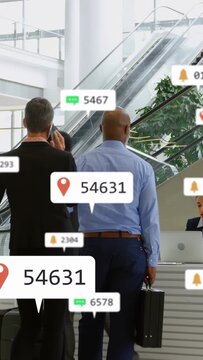 Business travelers entering lobby, AR tags updating above phones while queuing at desk checking in