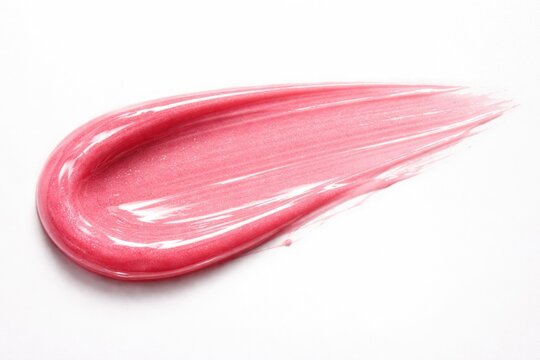 Close up of pink lip gloss smear on smooth white background with copy space