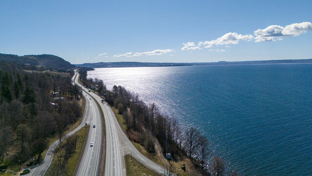 "Aerial view of E4 highway running along V&auml;ttern lake near J&ouml;nk&ouml;ping, Sweden - Scenic road trip"