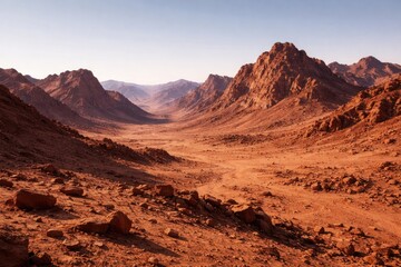 Obraz premium Dry Martian terrain featuring rugged mountains under a clear sky