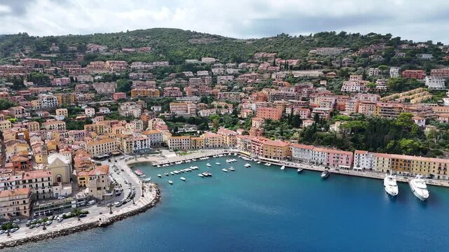 Panoramic Aerial sweep of Porto Santo Stefano town and Mediterranean harbor