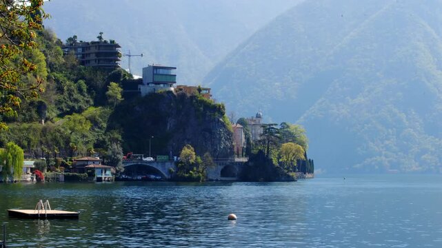 Static shot of boats in Lugano marina at Lake Lugano with Monte San Salvatore peak, Switzerland