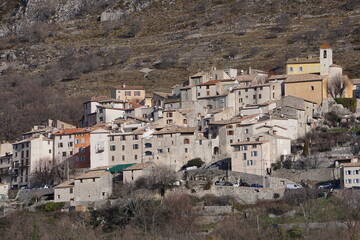 Obraz premium mountain landscape with snow and trees and the village of coursegoules, southern france
