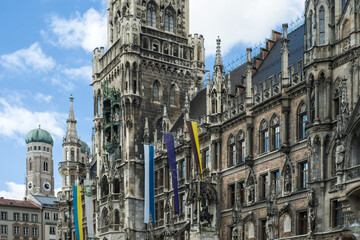 Obraz premium Gothic building with towers and flags under blue sky