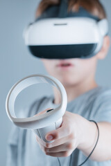 A gamer wearing virtual reality glasses with controllers and a headset © Alexander