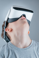 A boy enthusiastically explores the virtual world in a VR helmet © Alexander