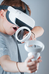 A gamer wearing virtual reality glasses with controllers and a headset © Alexander