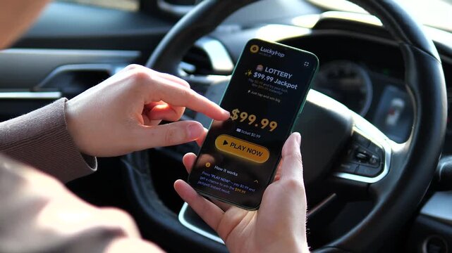 High-stakes mobile lottery game on the go. Hands holding a smartphone with a lucky jackpot interface inside a vehicle. Great for finance, app promotion, and digital gambling documentaries. Authentic