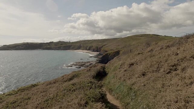 POV Walking alone on a coastal footpath in Cornwall, UK