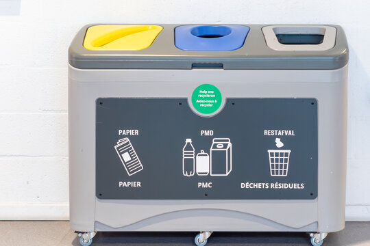 Modern three-compartment waste segregation bin for recycling in public spaces. Professional recycling station with labels for paper, plastic, and residual waste.Eco-friendly waste management system: a