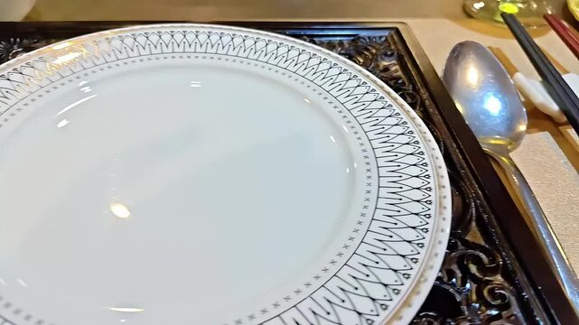 Dinner table setting with a plate, fork, spoon, and chopsticks, Restaurant Feast Banquet Silverware, Eating Ettiquette, Clean Dishware, Panning Shot