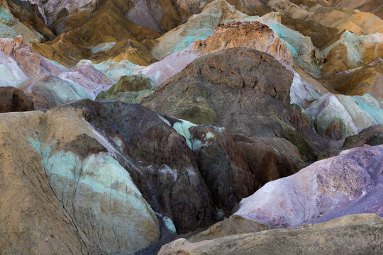 Colorful mineral formations and textured badlands in Death Valley, abstract desert geology background