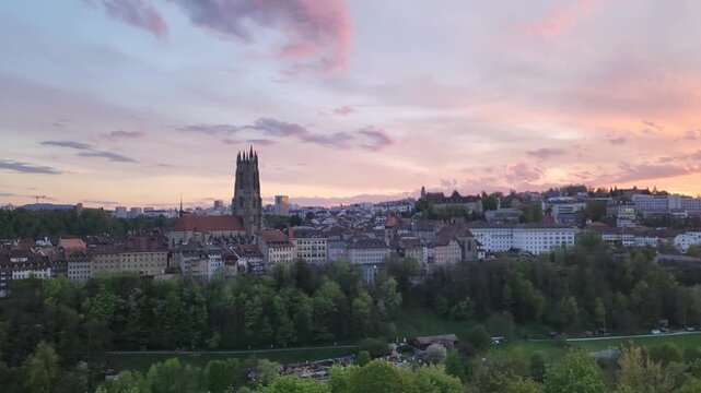 Fribourg, Switzerland, paning camera movement over the city skyline during sunset with dramatic sky colors.