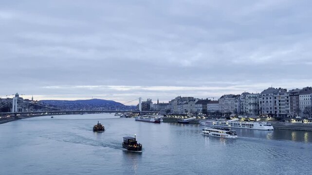 Hungarian Danube panorama. Winter evening in Budapest, view on Gellert Mountain and boats.
