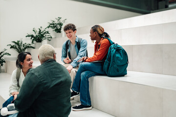 Obraz premium Diverse students conversing and learning together on campus steps, sharing ideas and building friendships
