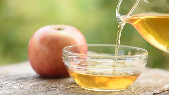 Apple and Apple Cider Vinegar on natural background.