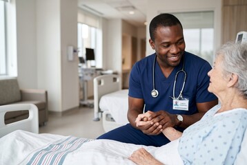 Obraz premium Compassionate African American male nurse holding the hand of an elderly female patient in a hospital room, providing comfort and support