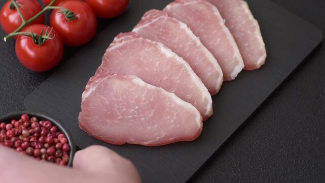 Smoked or dry cured meat slices, pork or ham with salt and spices. Smoked meat slices as a food background for your design