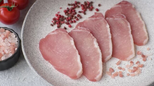 Smoked or dry cured meat slices, pork or ham with salt and spices. Smoked meat slices as a food background for your design