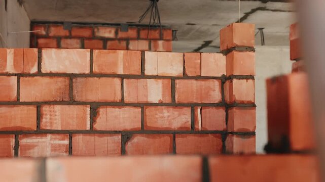Brick wall under construction with fresh mortar joints