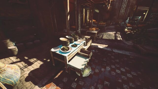 Bright kitchen prep station with stacked plates and bowls on workbench, dramatic light and long shadows reveal glaze details and utensil drawers, scene suggests