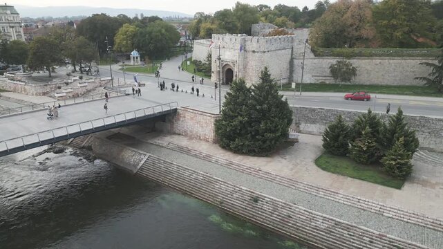 Rotating drone view of the historic medieval fortress gate near the river in central Nis, southern Serbia.