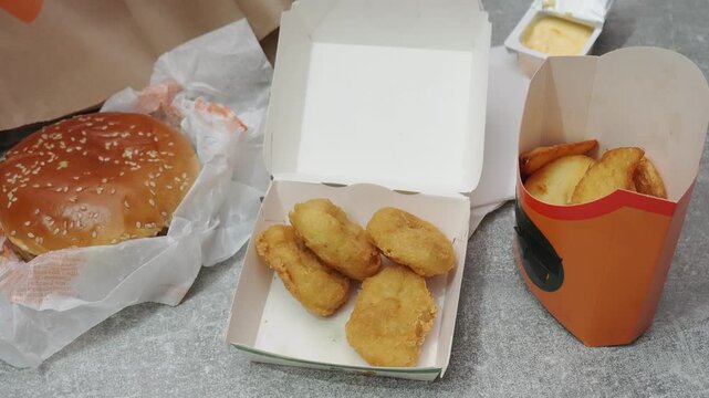 Fast food delivery menu background with various burgers, cheeseburger, nuggets, french fries, fizzy soda drinks. Junk unhealthy fast food, Ultra processed food with low nutrition, high calories value