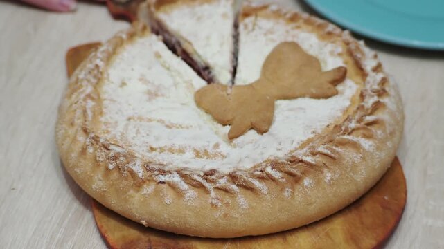 A girl at home cuts a freshly baked pie with berries, Apple pie baking as a sweet dessert with a golden lattice crust