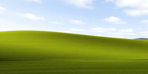 Obraz premium A serene green hill under a blue sky with white clouds on a sunny day in a natural landscape