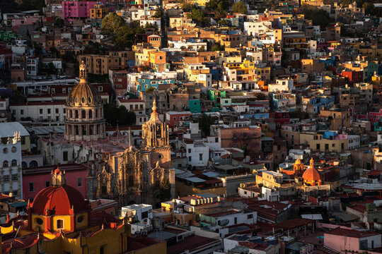 Aerial view of colorful colonial architecture in Guanajuato Mexico at sunset showcasing vibrant buildings and historic churches