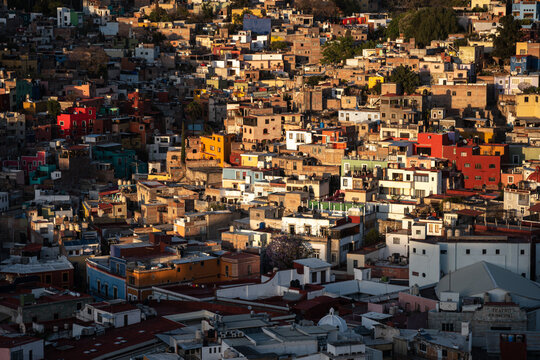 Vibrant colorful houses in Guanajuato Mexico during sunset showcasing urban landscape and architecture