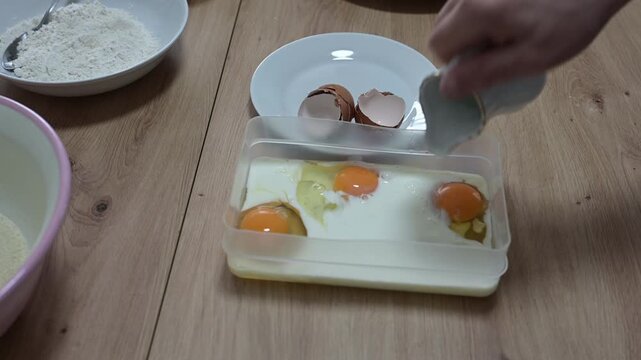 Three eggs and milk whisking with a fork