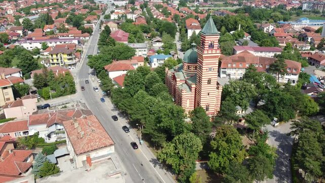 Drone descent revealing panorama of Paracin with Orthodox church in foreground, Serbia