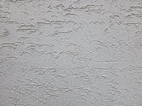 Rough white plaster wall texture with detailed surface pattern