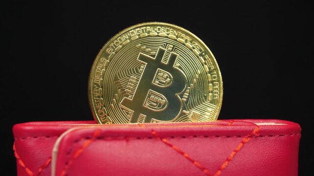 Gold bitcoin coin stored in a digital crypto wallet representing blockchain technology and bitcoin mining concept, zoom-out video