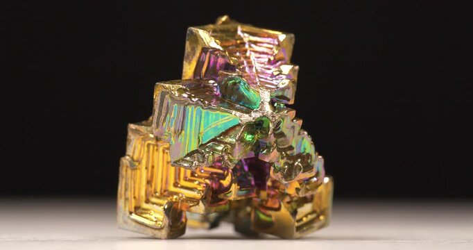 Bismuth crystals. Bismuth - chemical element with symbol Bi and atomic number 83. Post-transition metal and one of pnictogens. Synthesized bismuth crystal. Iridescent coloration is due to oxide film