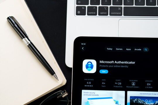 Microsoft Authenticator logo in Apple Liquid Glass iOS 26 interface on iPad photographed in clean workspace closeup. Stafford, United Kingdom, April 13, 2026.