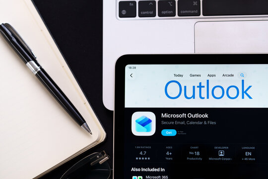 Microsoft Outlook logo in Apple Liquid Glass iOS 26 interface on iPad photographed in clean workspace closeup. Stafford, United Kingdom, April 13, 2026.