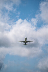 Fototapeta premium Passenger airplane flying in cloudy blue sky