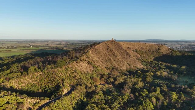 Valley Lake Conservation Park, Mount Gambier, South Australia in autumn: 4K aerial drone footage of crater lake, forested hills, Centenary Tower, seasonal foliage and natural landscape near Blue Lake