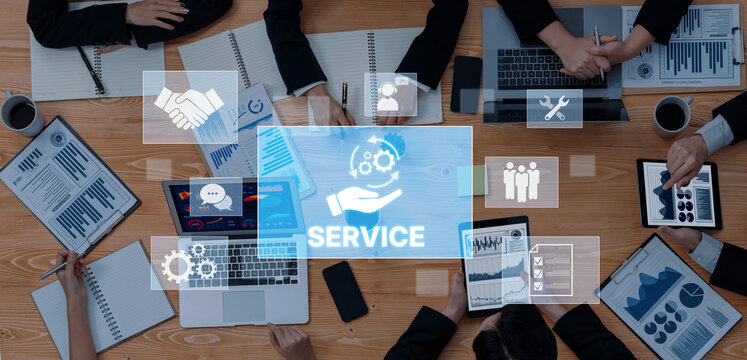 Group of professionals in a business meeting discussing service strategies using digital devices and data charts, emphasizing teamwork and effective communication. Trope