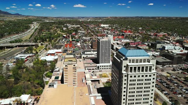Urban skyline with church rail line and mountain foothills