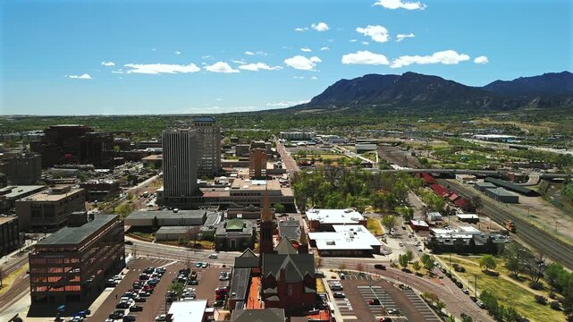 Urban skyline with church rail line and mountain foothills