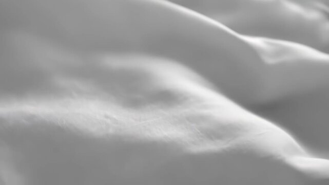 Close-up of rumpled white fabric with soft, gray shadows