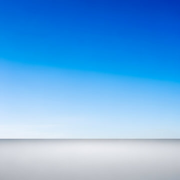 Expansive gradient of brilliant blue sky fading into a soft white horizon, above a pristine light grey surface. A clean, minimalist abstract background for serene, open, conceptual designs