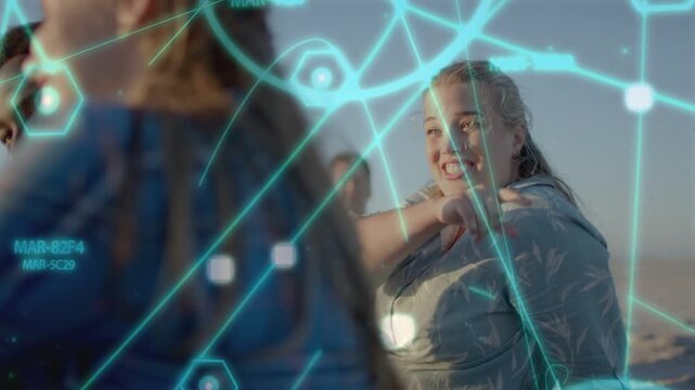 Group on beach, woman on right pointing, laughing while glow overlay mapping marketing across faces